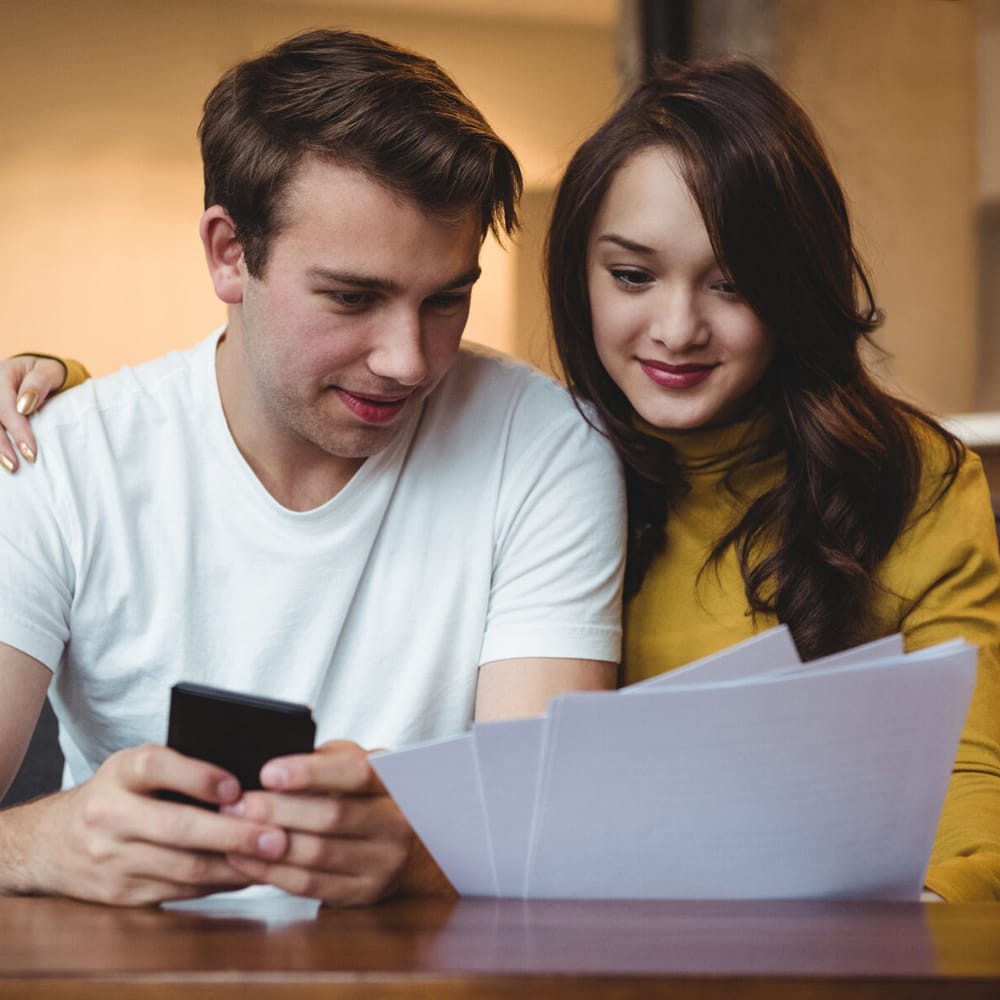 couple-discussing-with-financial-documents-calculator-living-room_107420-84894